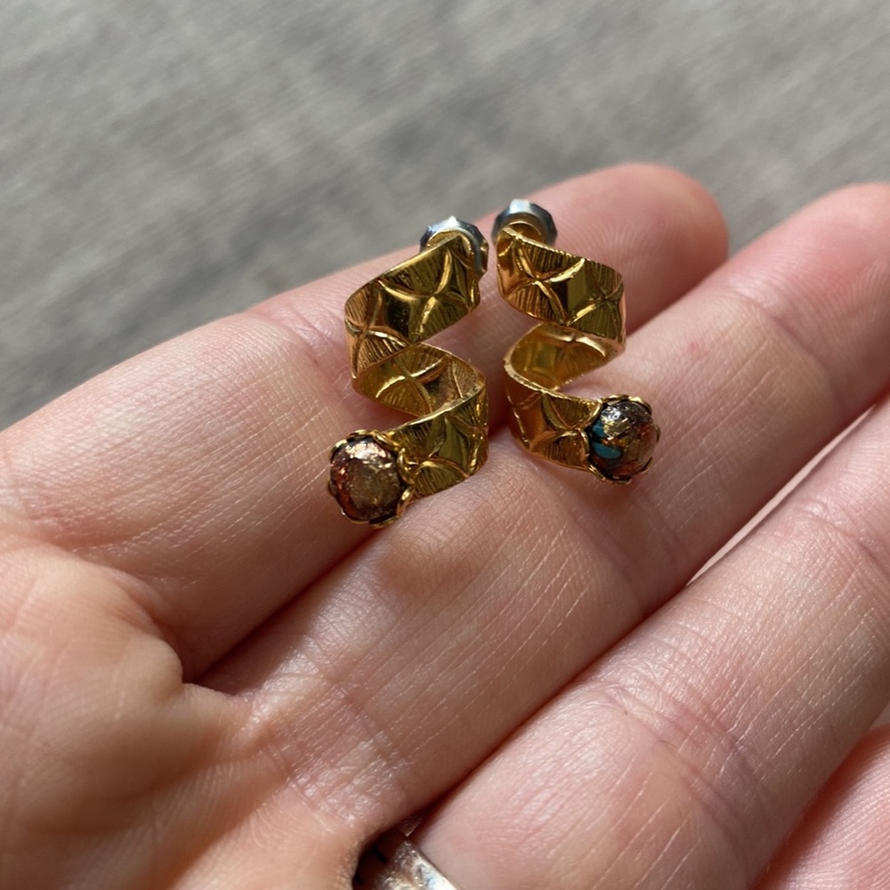 Gold spiral earrings with iridescent jewels